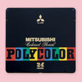 Mitsubishi Polycolor No. 7500 colored pencil set in a black metal tin featuring bold vintage-style lettering in red, blue, green, and yellow blocks, with the Mitsubishi logo and 24 Colors printed in gold on a pink background