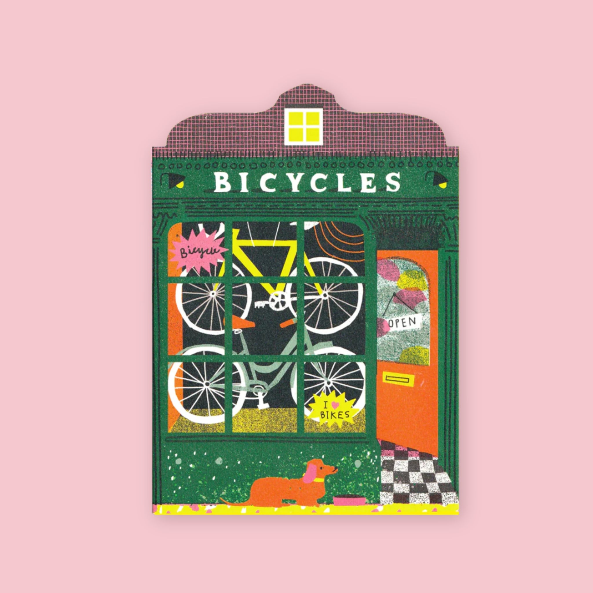 The Printed Peanut die cut greeting card shaped like a dark green bicycle shop storefront with a yellow bike in the window