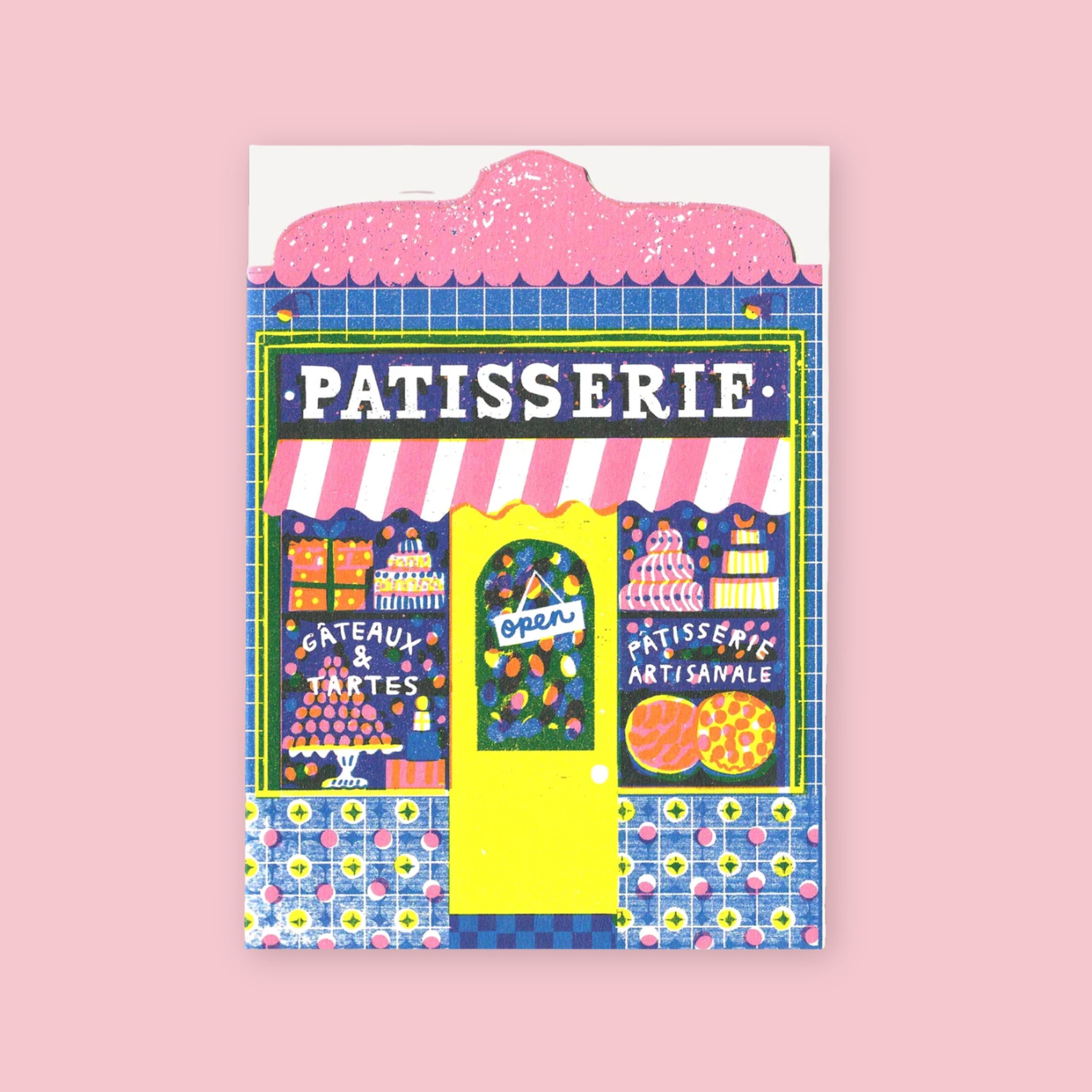 The Printed Peanut die cut greeting card shaped like a French patisserie storefront with pastries and colorful displays in the window