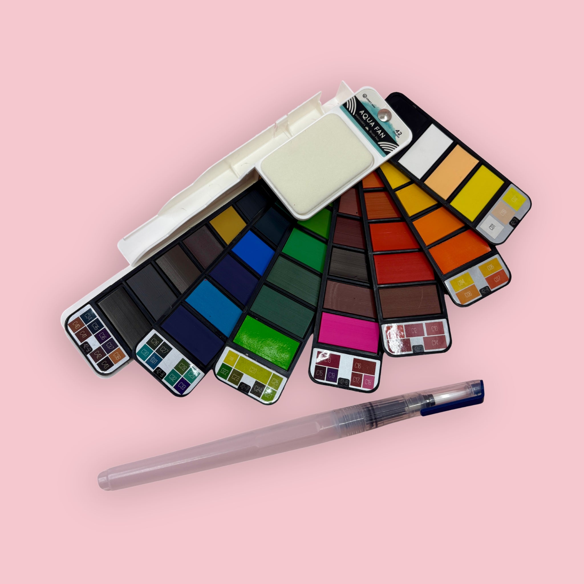 Fan-style watercolor palette with water brush, shown open against a pink background.