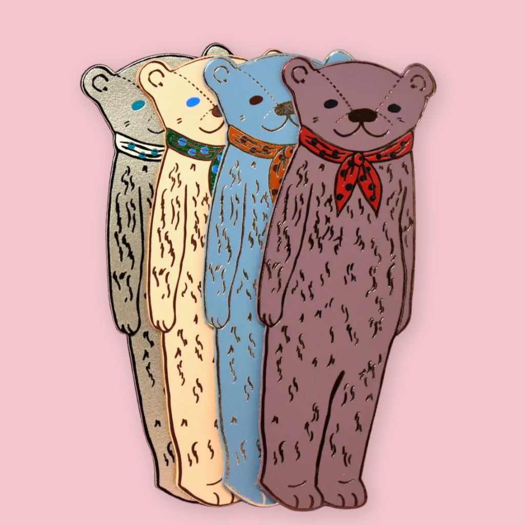 Set of four Ark Colour Design leather bookmarks shaped like bears, shown in different colors on a pink background.