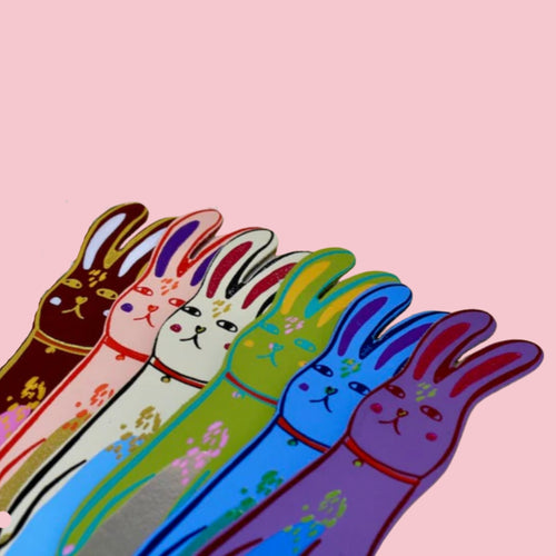 Colorful Ark Colour Design rabbit-shaped bookmarks with illustrated bunny faces on a pink background