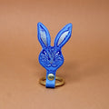 Ark Colour Design rabbit keychain in blue with a gold ring and detailed rabbit face illustration.