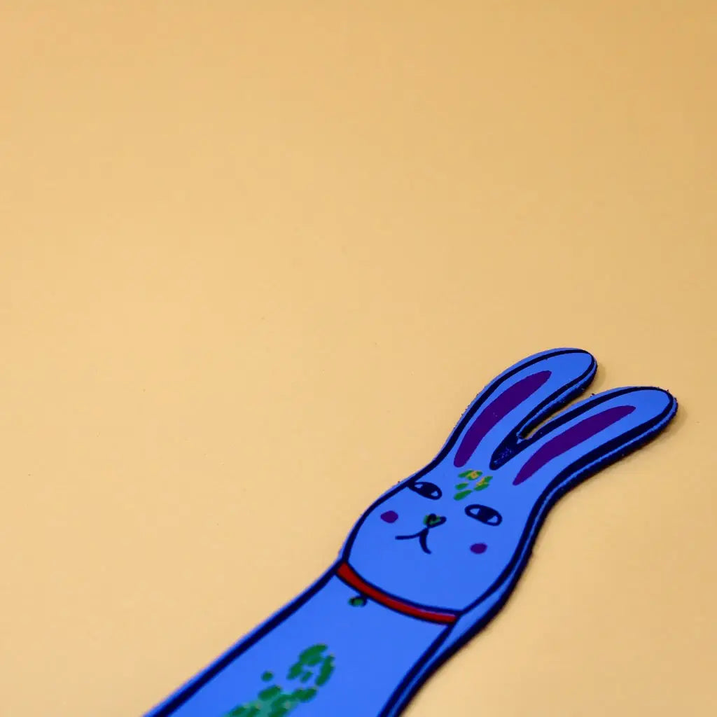 Blue Ark Colour Design rabbit bookmark with illustrated bunny face on a beige background