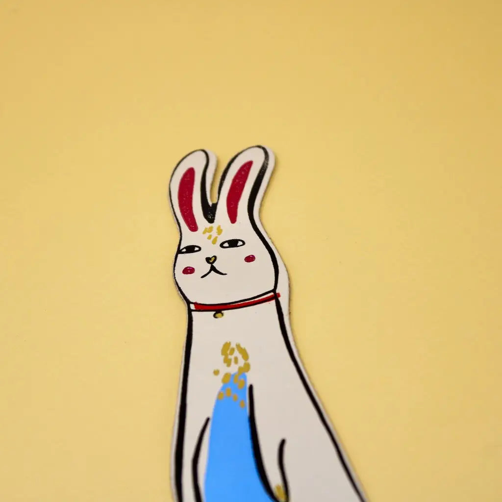 Cream Ark Colour Design rabbit bookmark with illustrated bunny face on a beige background