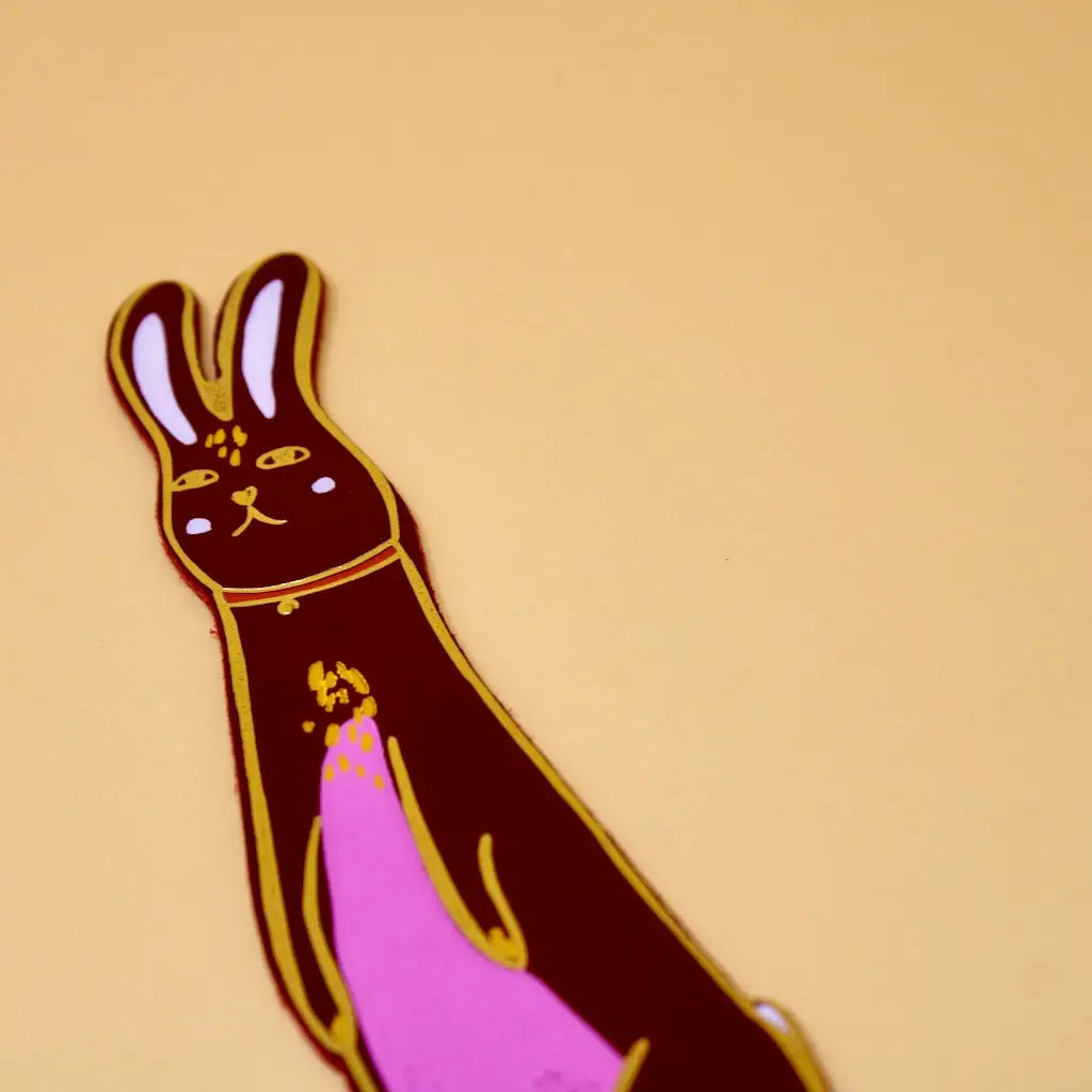 Red Ark Colour Design rabbit bookmark with illustrated bunny face on a beige background