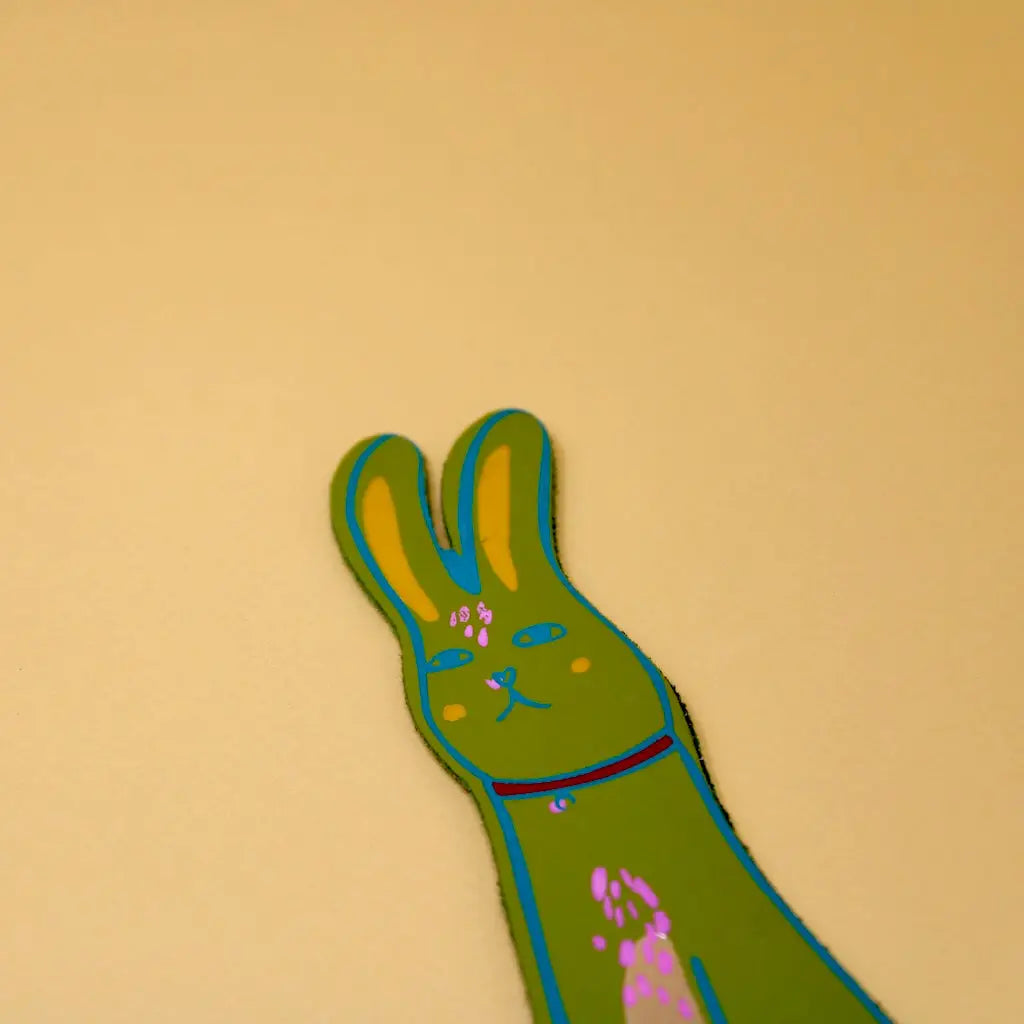 Apple green Ark Colour Design rabbit bookmark with illustrated bunny face on a beige background