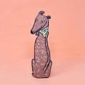 Greyhound-shaped bookmark wearing a green polka dot bandana, sitting upright, on a peach background.