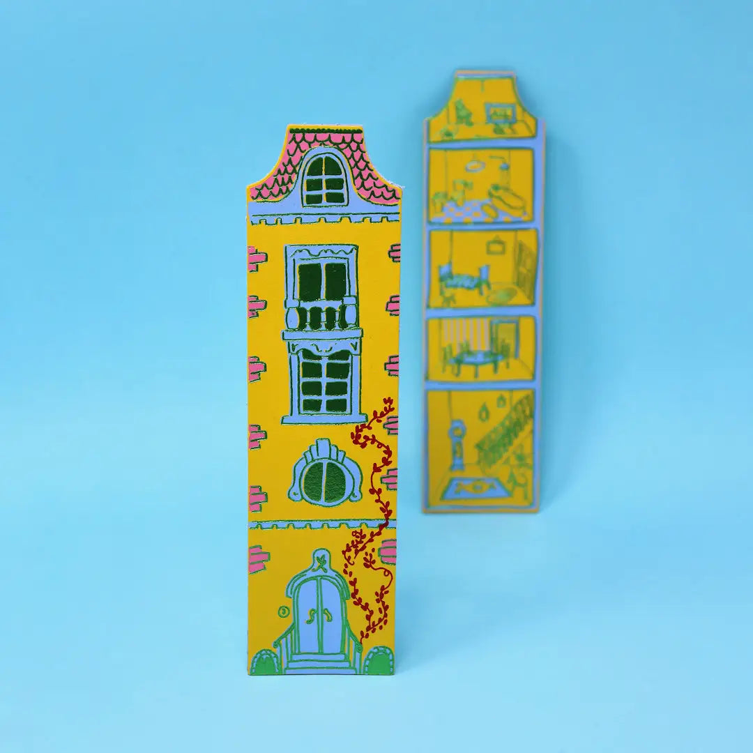Ark Colour Design yellow dollhouse-shaped bookmarks with illustrated doors and windows on a beige background