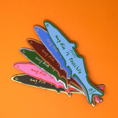Six fish-shaped bookmarks in blue, green, brown, pink, dark green, and black, each lettered "Any fin is possible, Ark Colour Design," fanned out on an orange background.