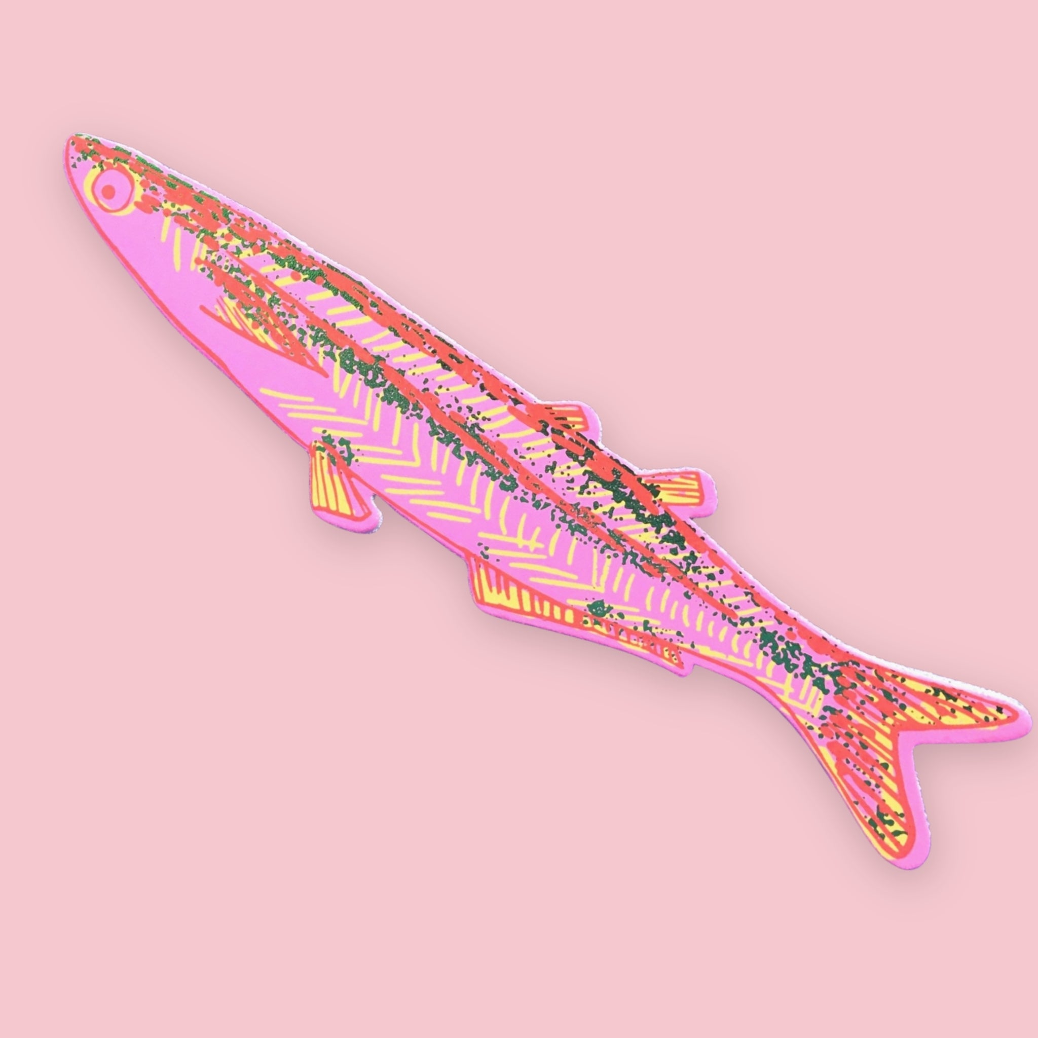 Pink fish-shaped bookmark with orange, yellow, and green patterned stripes, on a pink background.