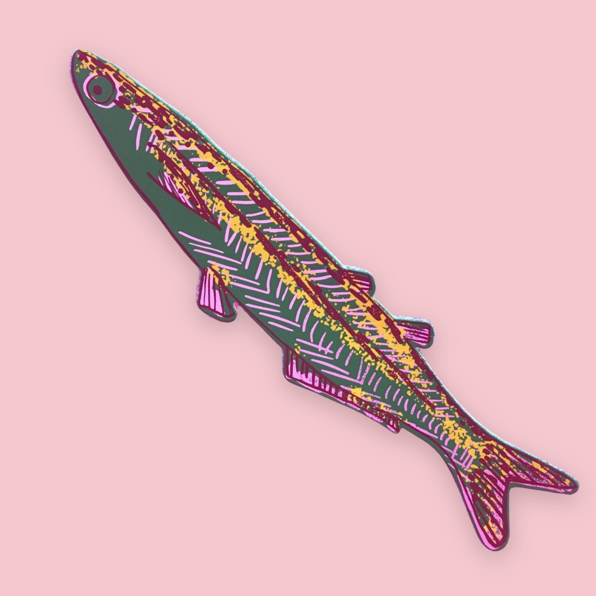 Green fish-shaped bookmark with pink, yellow, and burgundy patterned stripes, on a pink background.