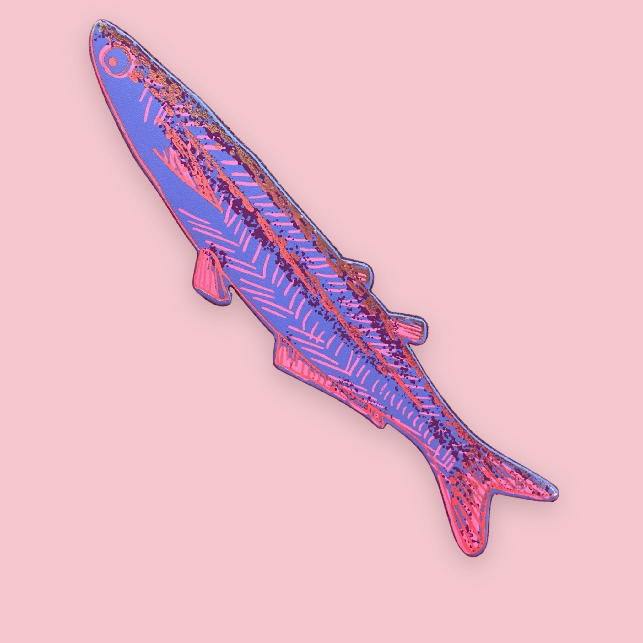 Blue fish-shaped bookmark with orange, pink, and burgundy patterned stripes, on a pink background.