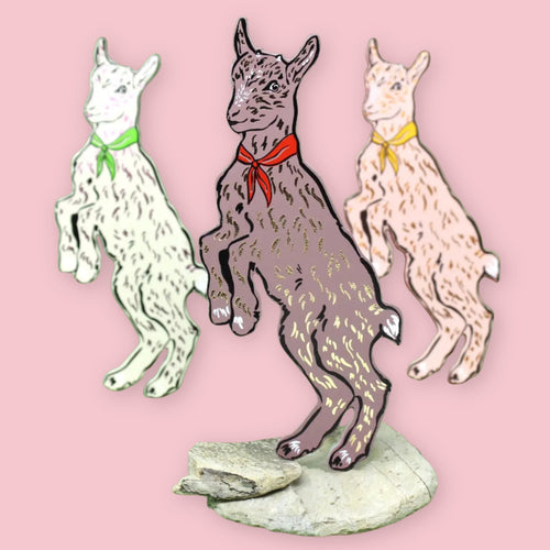 Three Ark Colour Design goat-shaped bookmarks with colorful neckerchiefs on a pink background