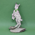Ark Colour Design white goat-shaped bookmark with a green neckerchief, standing on a green background