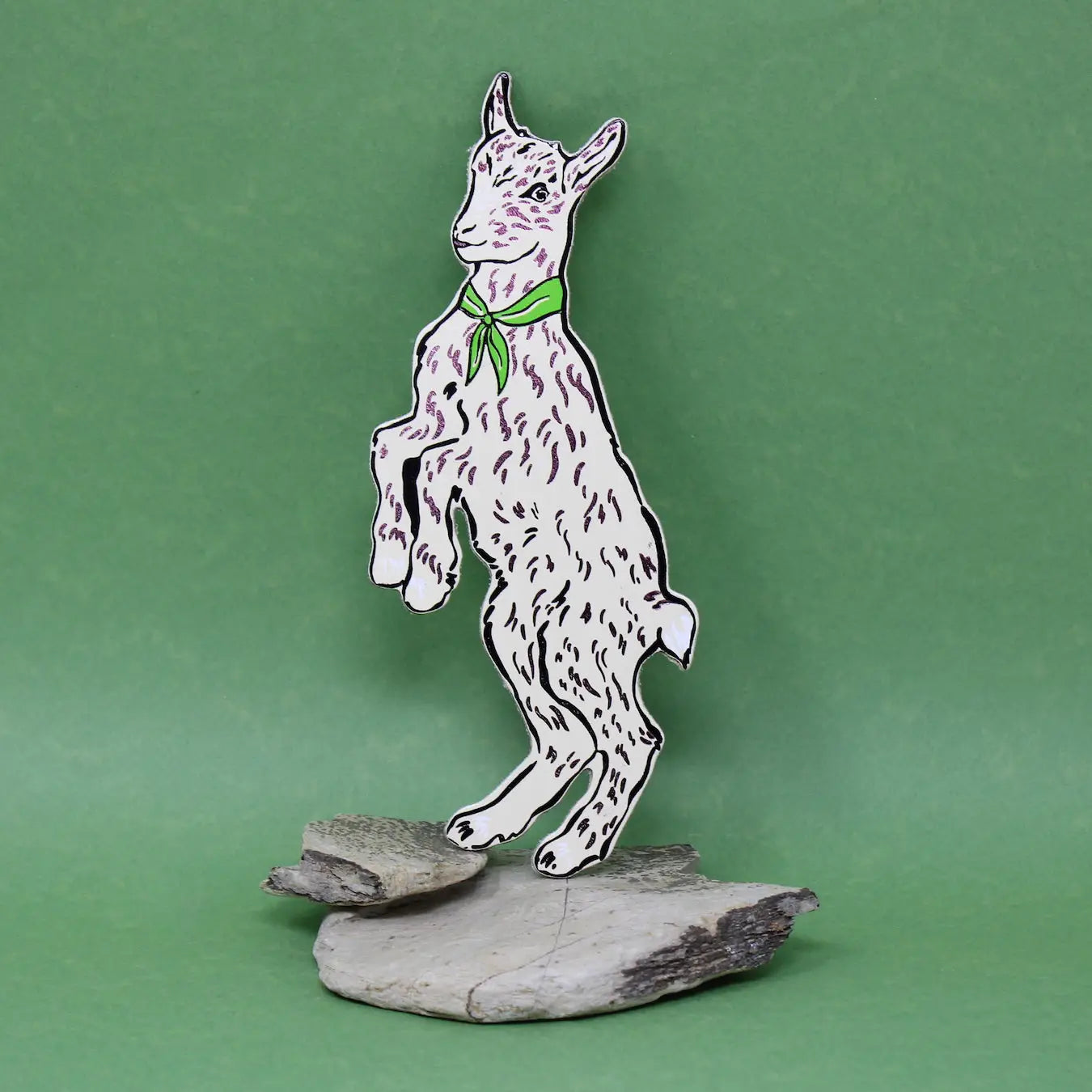 Ark Colour Design white goat-shaped bookmark with a green neckerchief, standing on a green background