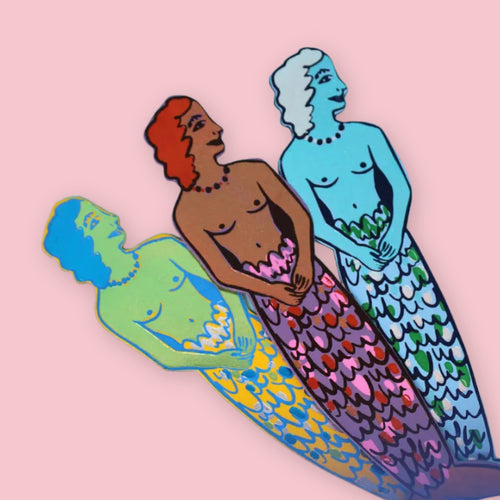 Set of three mermaid-shaped leather bookmarks in different colors, layered against a pale pink background.
