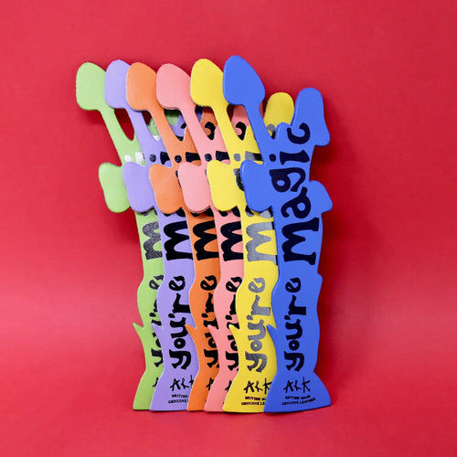 Six mushroom-shaped bookmarks in green, lilac, orange, pink, yellow, and blue, each lettered "You're Magic, Ark British Made," fanned out on a red background.