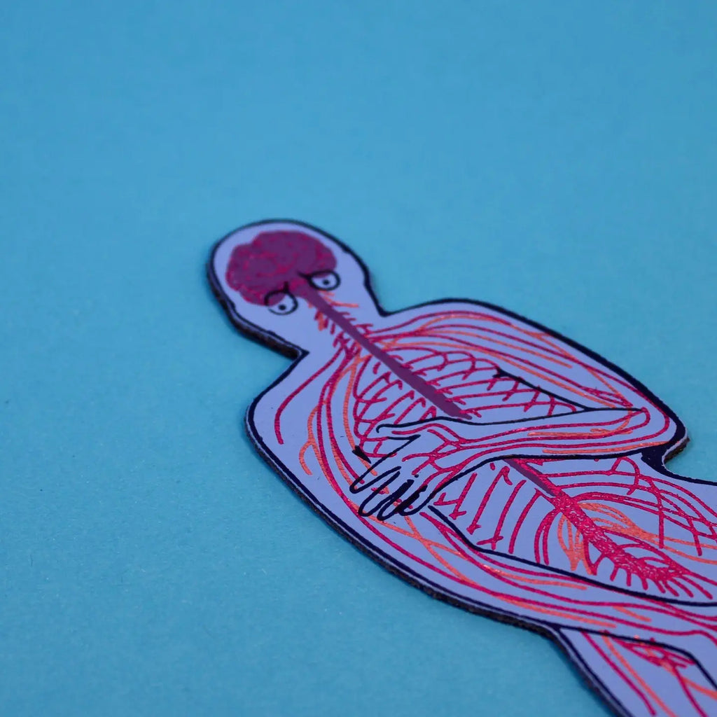 Close-up of a blue nervous system-shaped bookmark showing the brain and nerve pathways through the upper body, on a blue background.