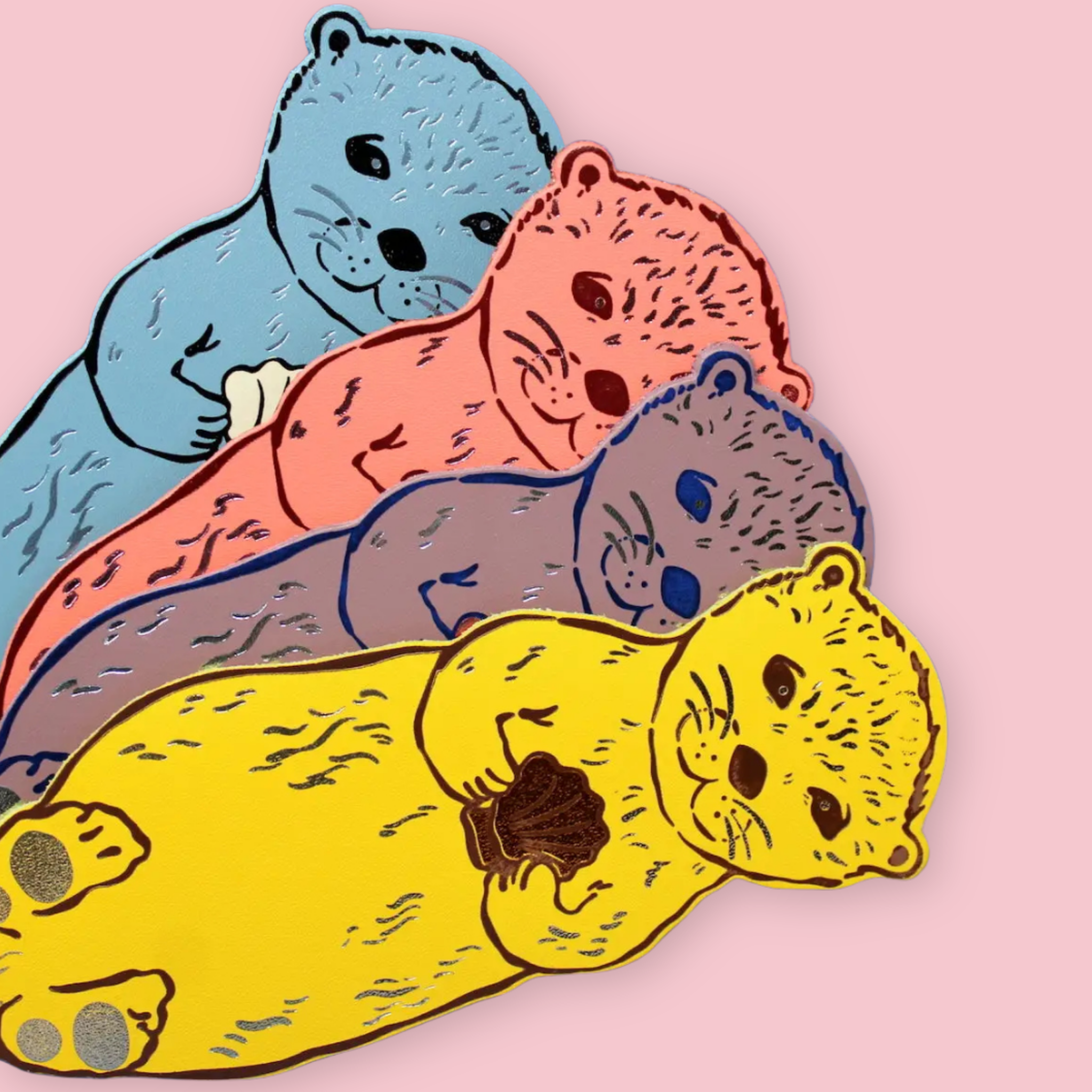 Four otter-shaped bookmarks in blue, coral, dusty lilac, and yellow, each holding a clam shell, on a pink background.