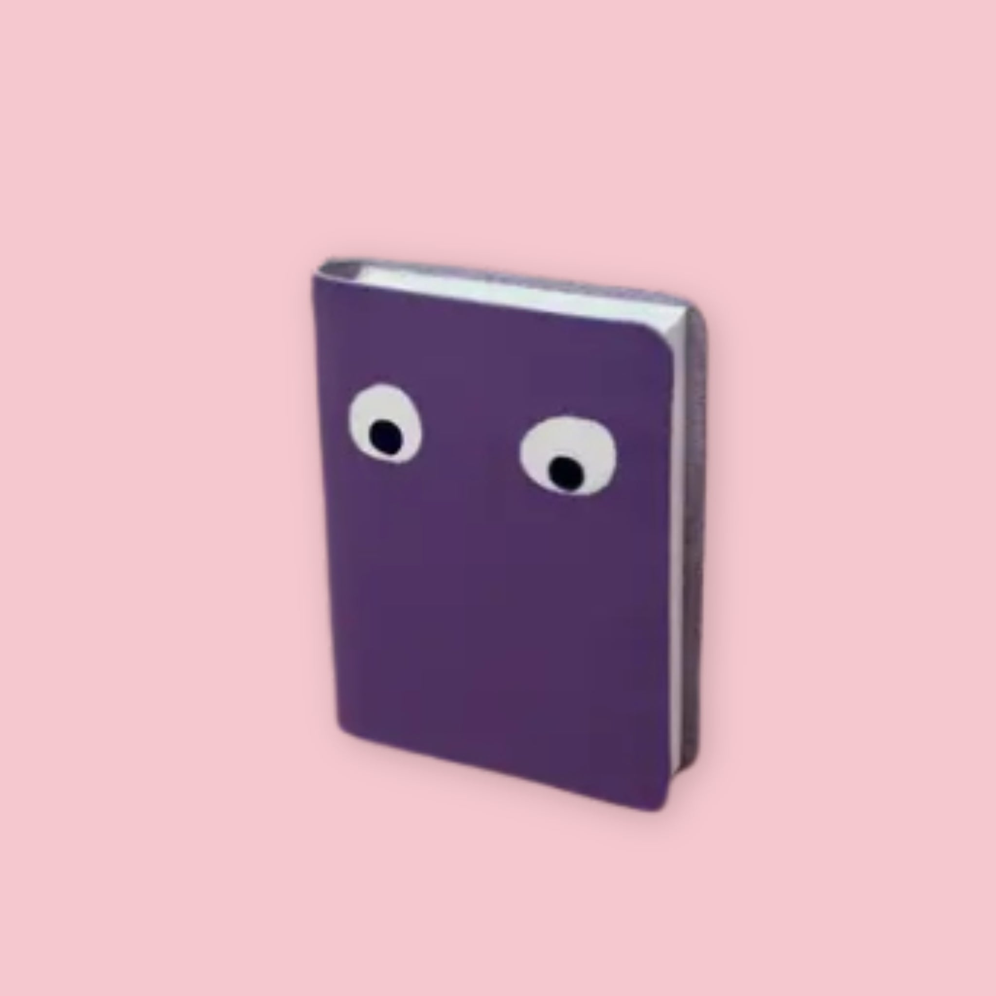 Ark Colour Design leather googly eye notebook in lilac with foil-embossed eyes on a pink background