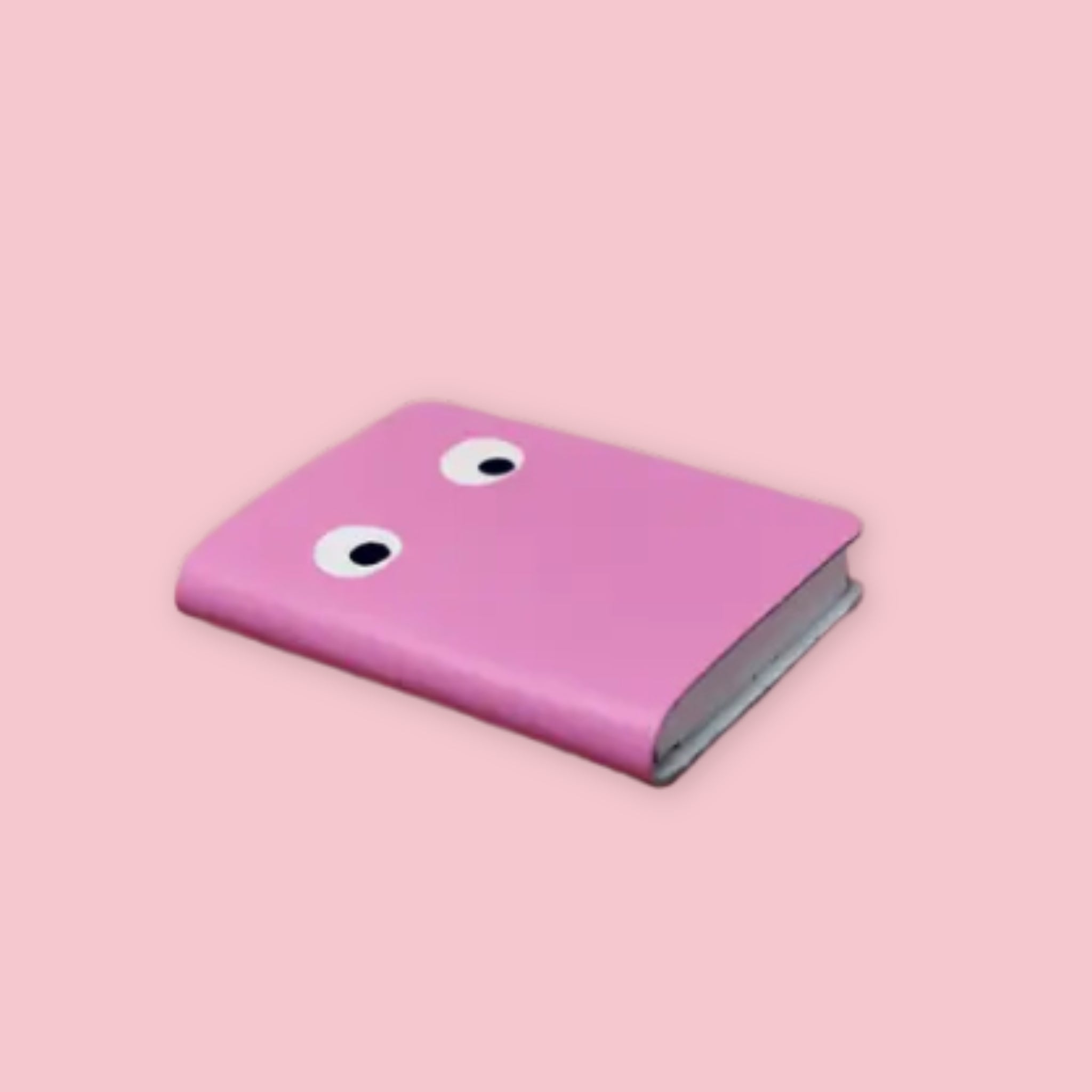 Ark Colour Design leather googly eye notebook in pink with foil-embossed eyes looking in different directions on a pink background