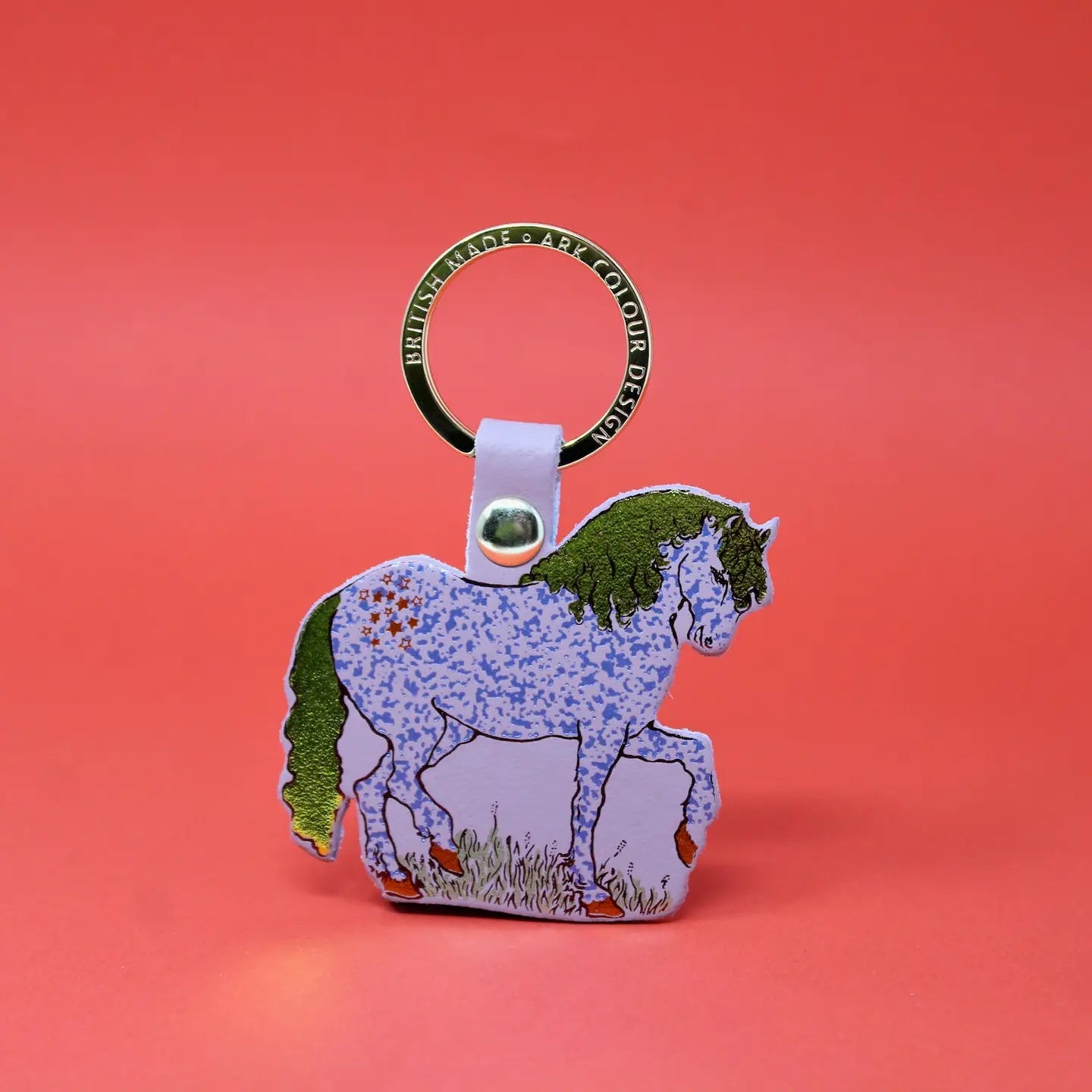 Ark Colour Design horse keychain with gold ring, nude beige leather loop, and illustrated nude beige horse design on a red background.