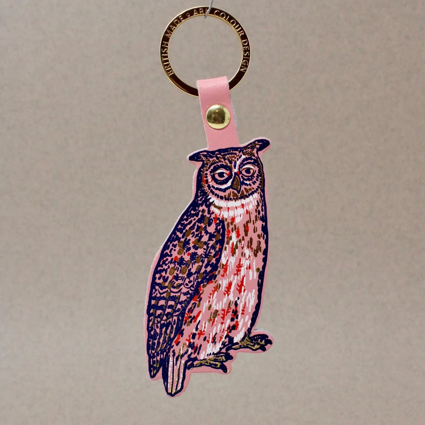 Ark Colour Design owl keychain with gold ring, pink leather strap, and illustrated owl design.