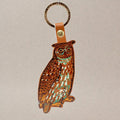 Ark Colour Design owl keychain with gold ring, brown leather strap, and illustrated owl design.