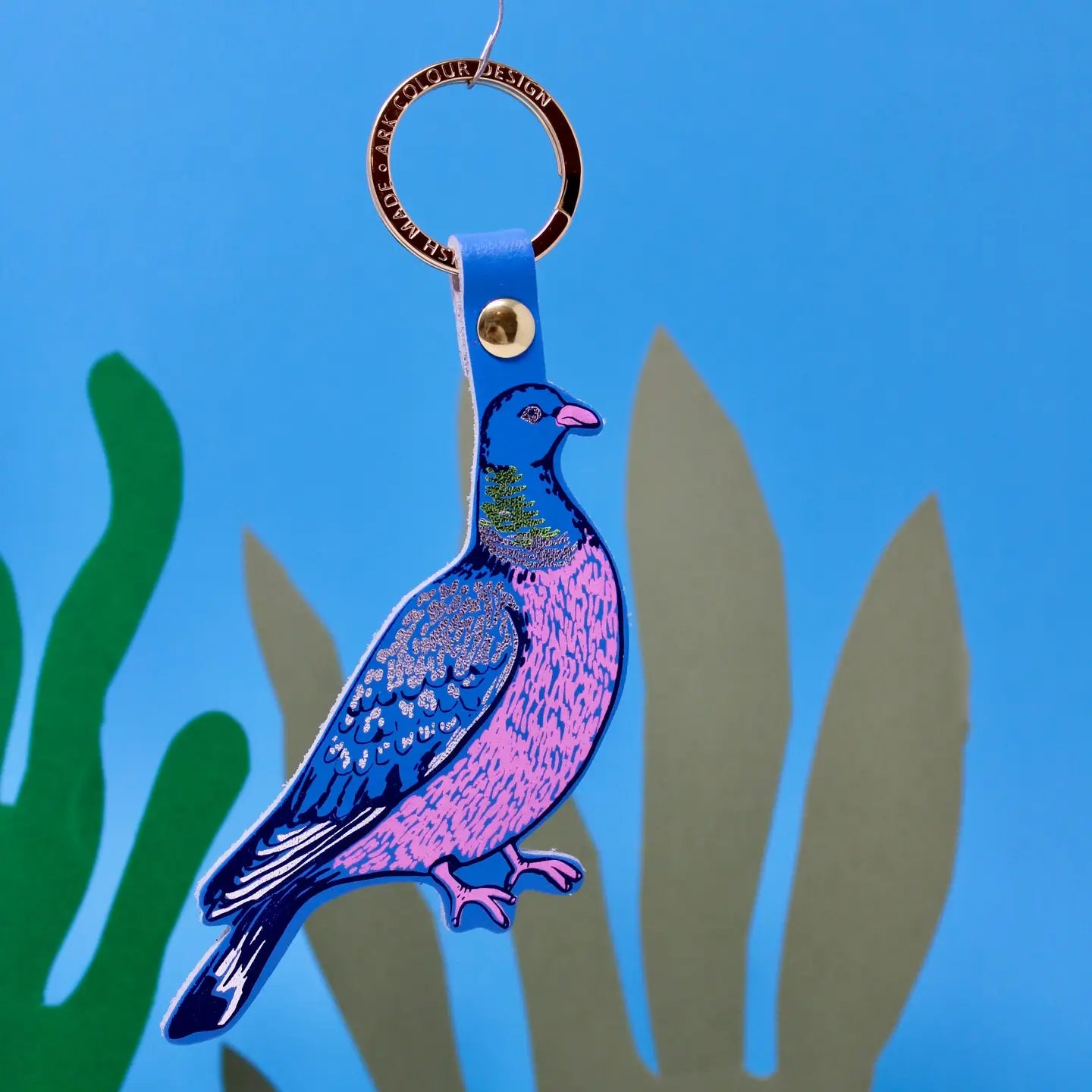 Keychain with a blue and pink pigeon design on a blue background