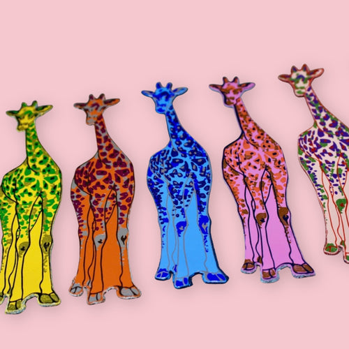 Set of five colorful leather bookmarks shaped like giraffes, arranged in a row on a pink background.