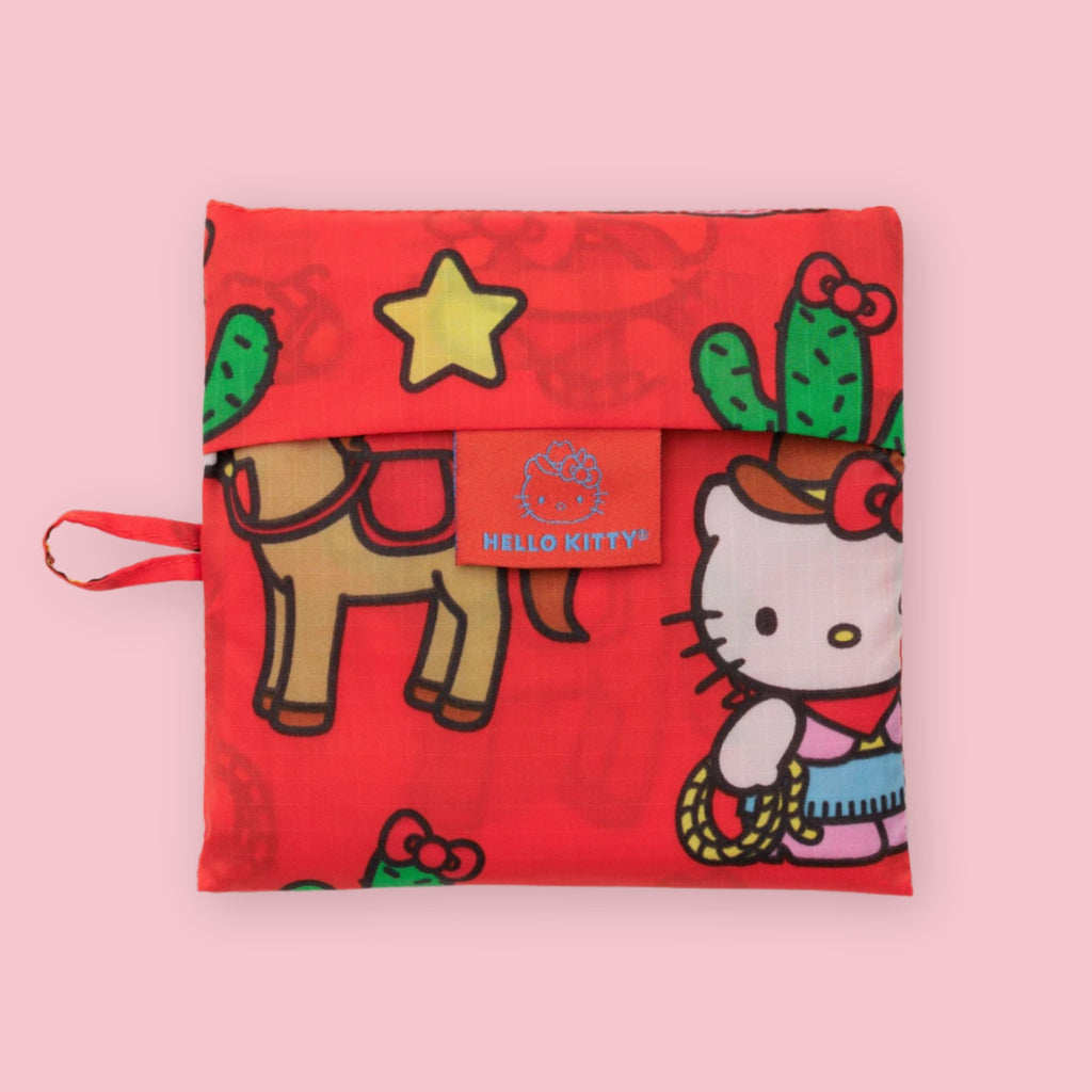 Hello Kitty western-themed Baggu pouch in red, featuring cactus, horse, star, and cowboy-style character illustrations.