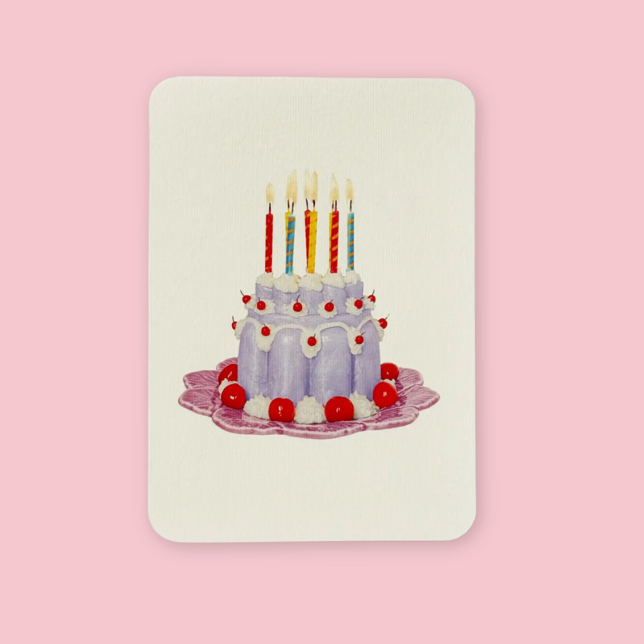 Canonbury Press greeting card featuring an illustrated lavender birthday cake with lit candles, white icing, and red cherries on a decorative plate.
