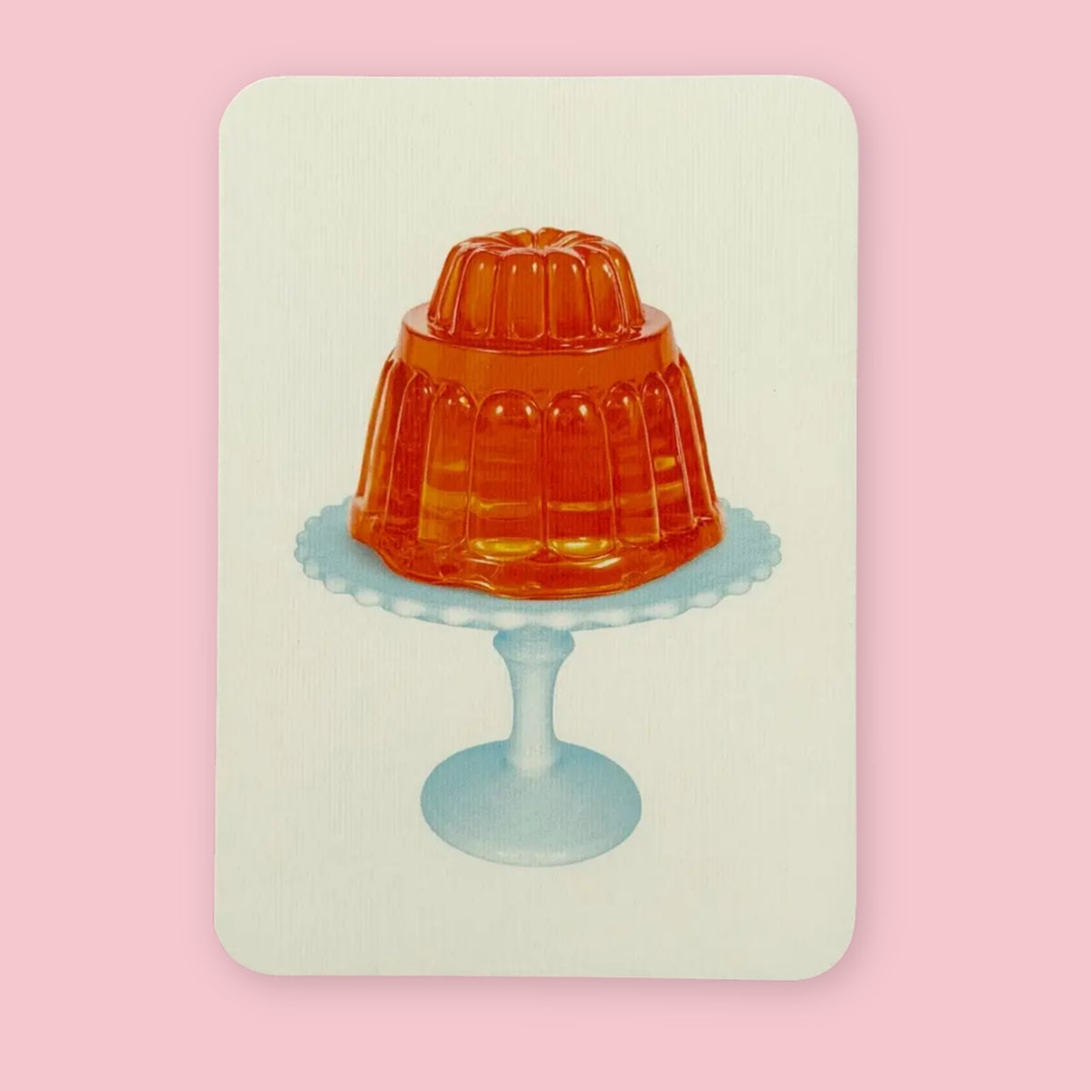 Canonbury Press greeting card featuring orange jelly on a pale blue pedestal plate against a pink background