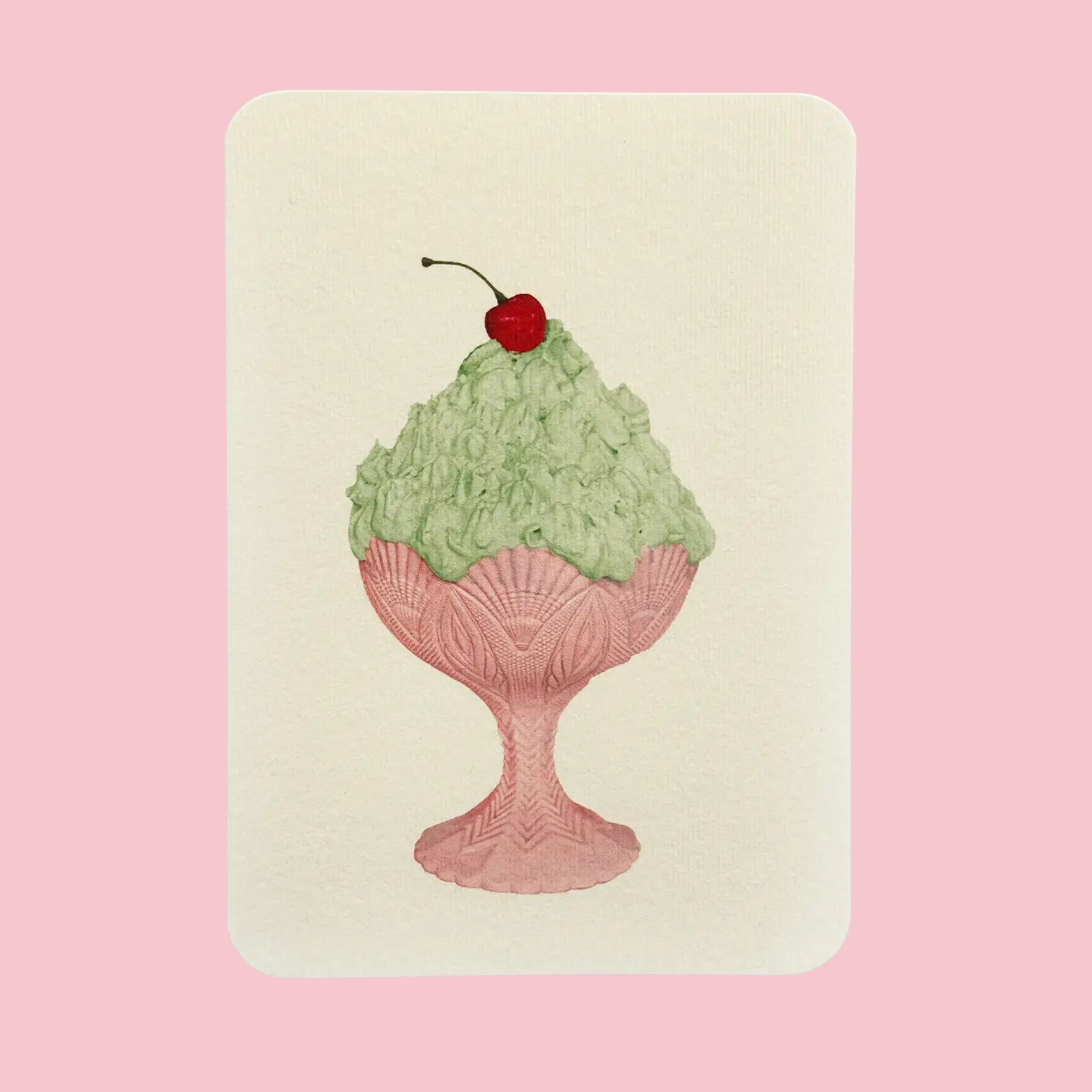 Canonbury Press Greeting card featuring an illustrated pistachio cream dessert in a pink glass sundae dish, topped with a red cherry, on a soft cream background.