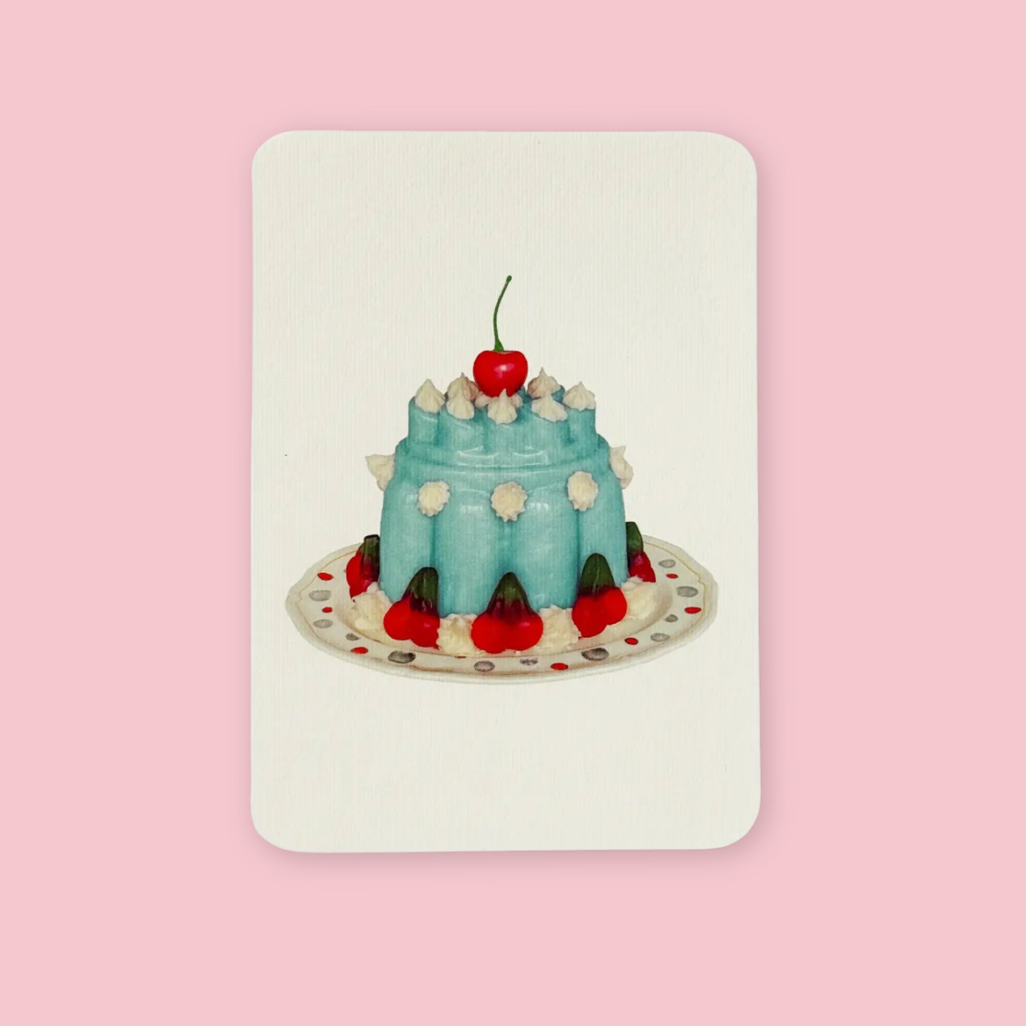 Canonbury Press greeting card featuring an illustrated blue cake topped with a cherry and surrounded by red cherries on a decorated plate, centered on a soft cream background.