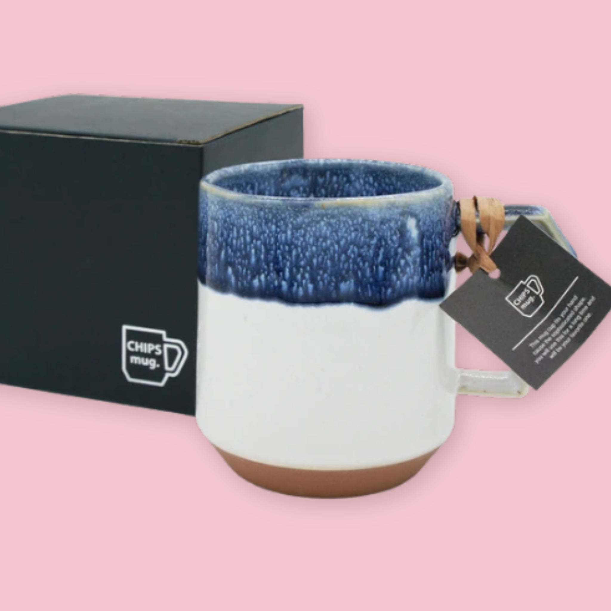 Chips Mug in Navy Drop with drip glaze over white and terracotta base with branded black gift box on a pink background