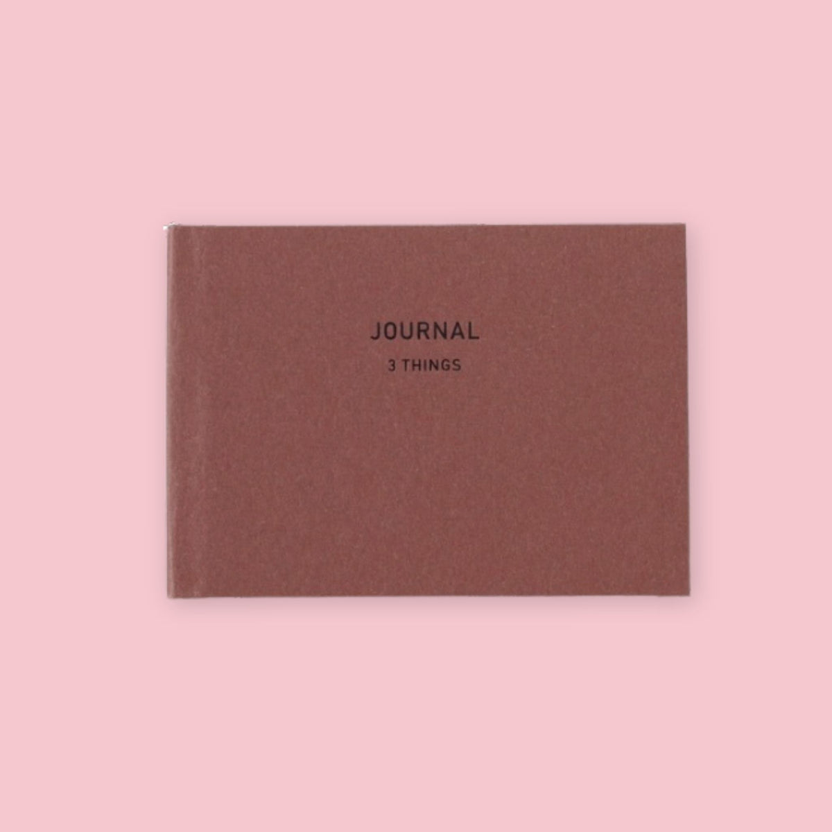 Dark Red Daigo Mini Easy Journal 3 Things with black lettering on a pink background.