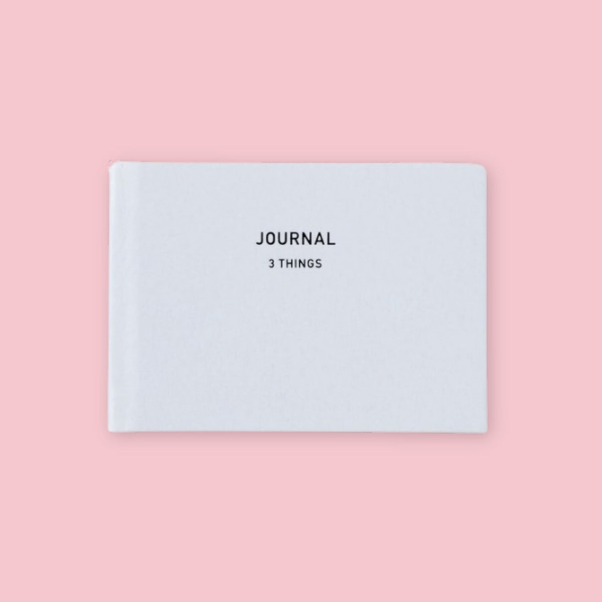 White Daigo Mini Easy Journal 3 Things with black lettering on a pink background.
