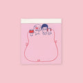 Die-cut memo pad featuring illustrated boy and girl sharing a red string on a pink background