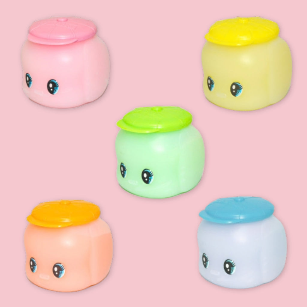 Set of five Fueki starch glue containers in soft pastel colors with matching lids on a pink background.