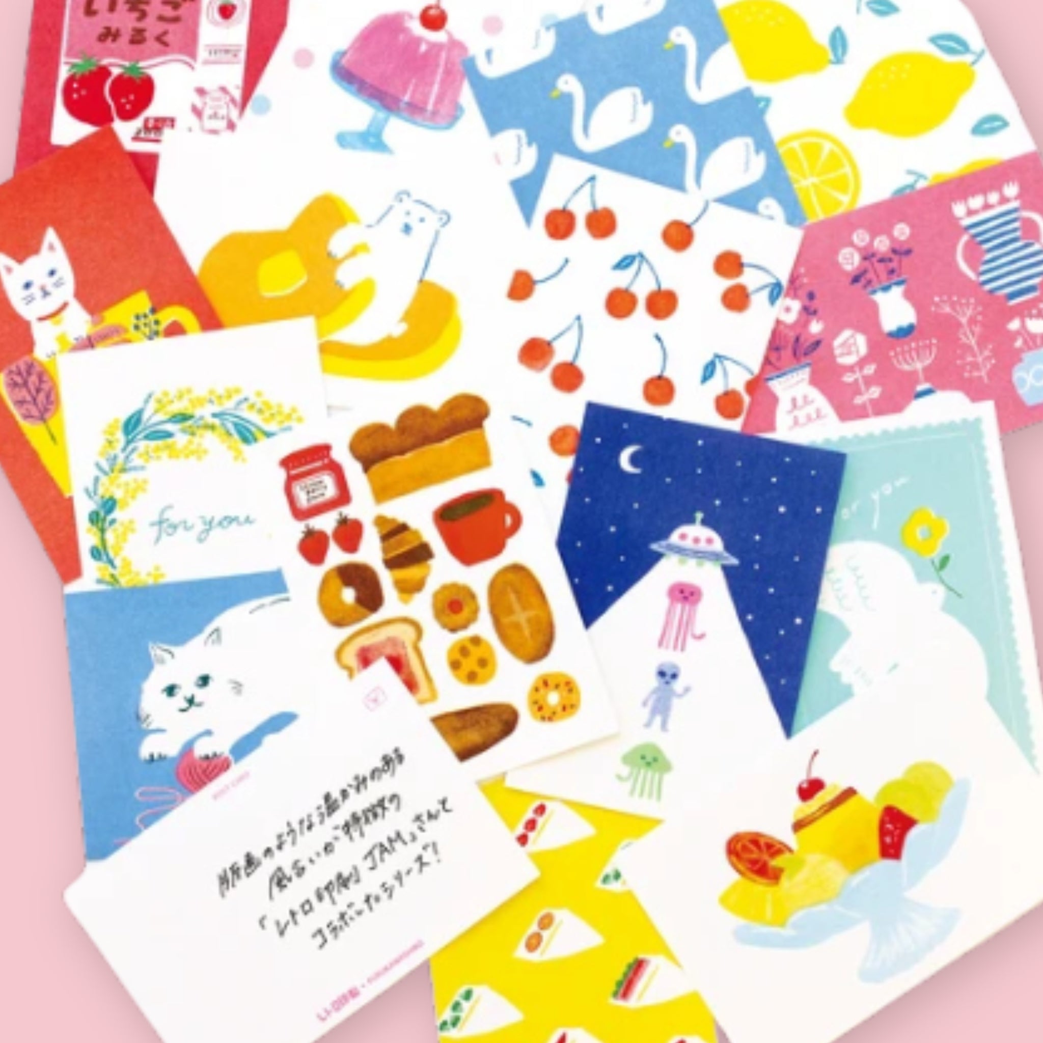 Assortment of Furukawashiko illustrated postcards spread out on a pink background