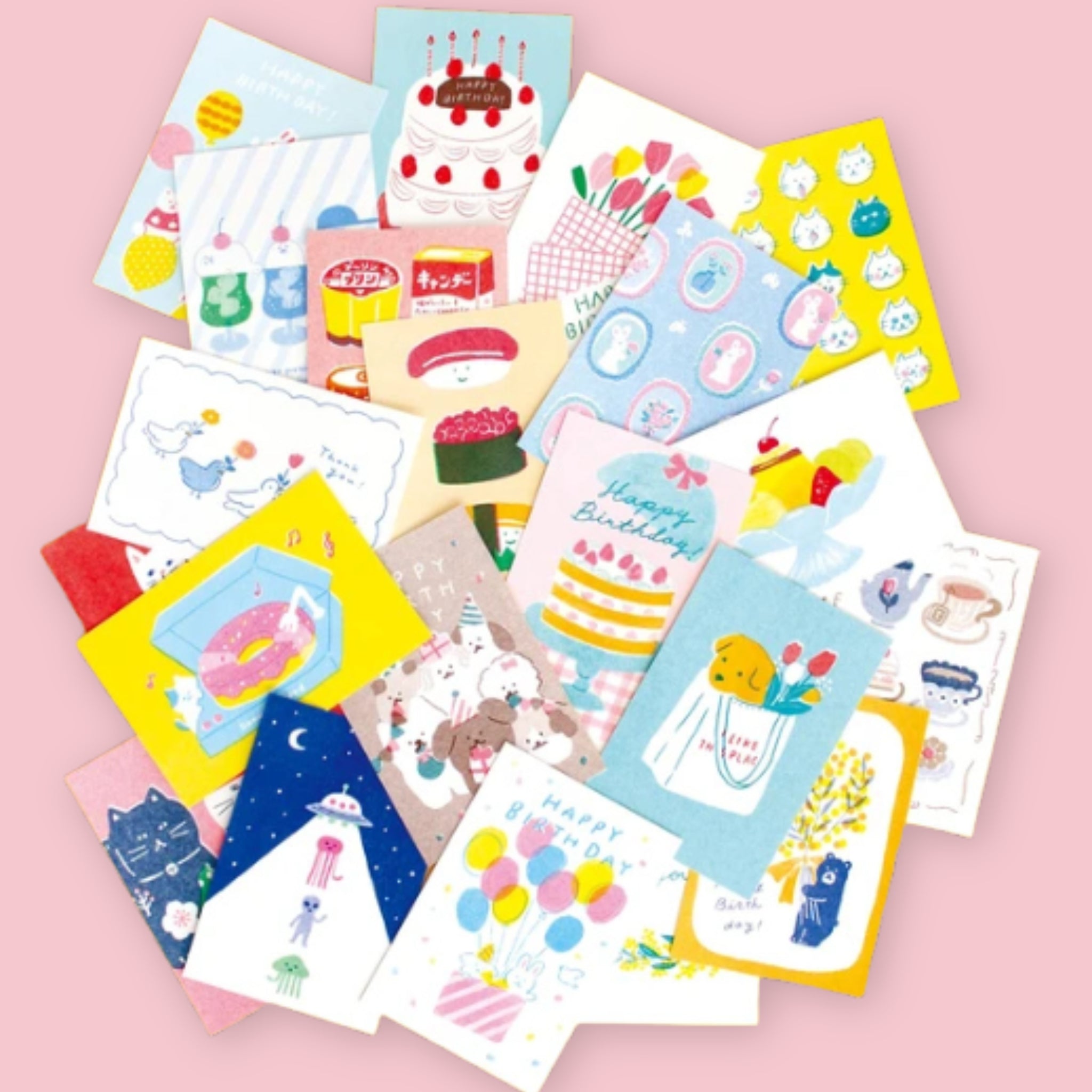 Assortment of Furukawashiko illustrated postcards spread out on a pink background