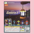 Yell Camping Lantern 2 gachapon featuring four light-up miniature lantern keychains in khaki, mustard, navy, and vermilion.