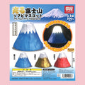 Yumeya light-up Mt. Fuji gachapon featuring blue, gold, and red miniature Mt. Fuji soft vinyl mascots.