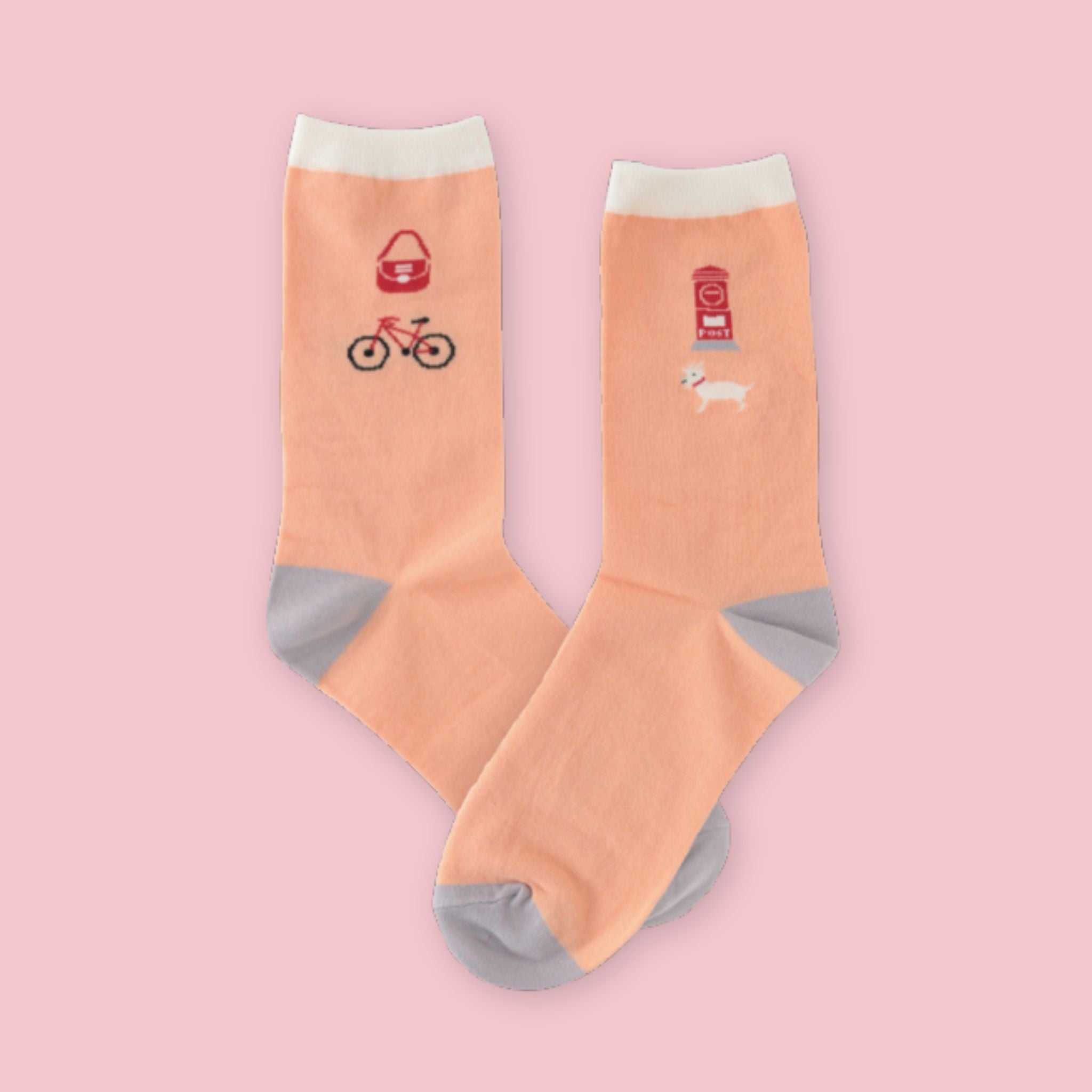 Garapago Socks in Post Box style featuring illustrated Japanese post box and bicycle on peach crew socks with gray heel and toe on a pink background