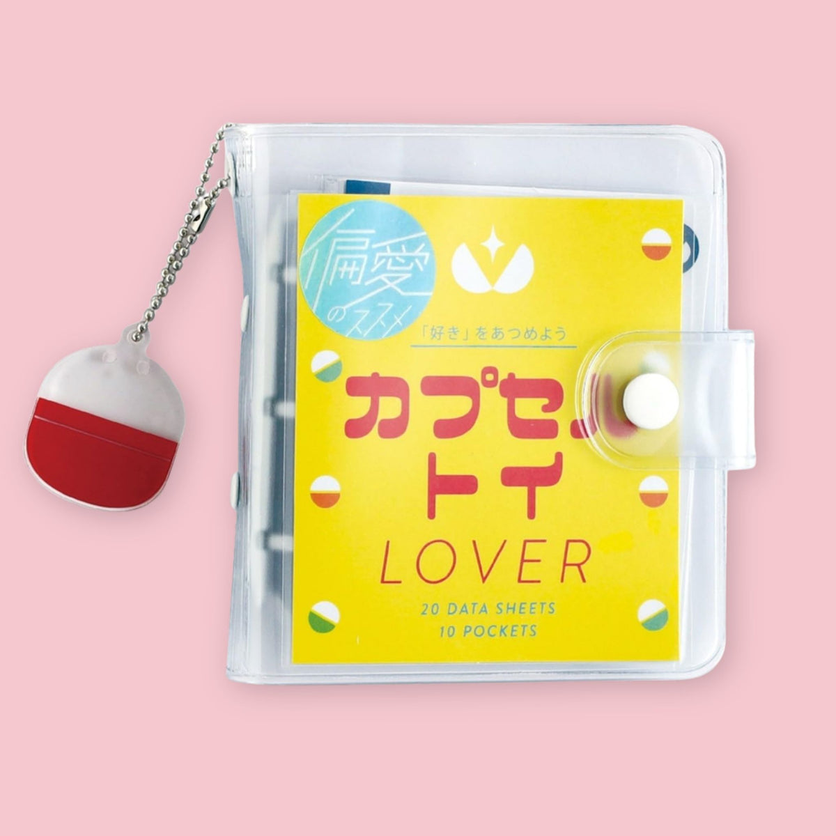 Green Flash Gachapon Lover Mini Binder with clear cover and capsule toy charm on a pink background.