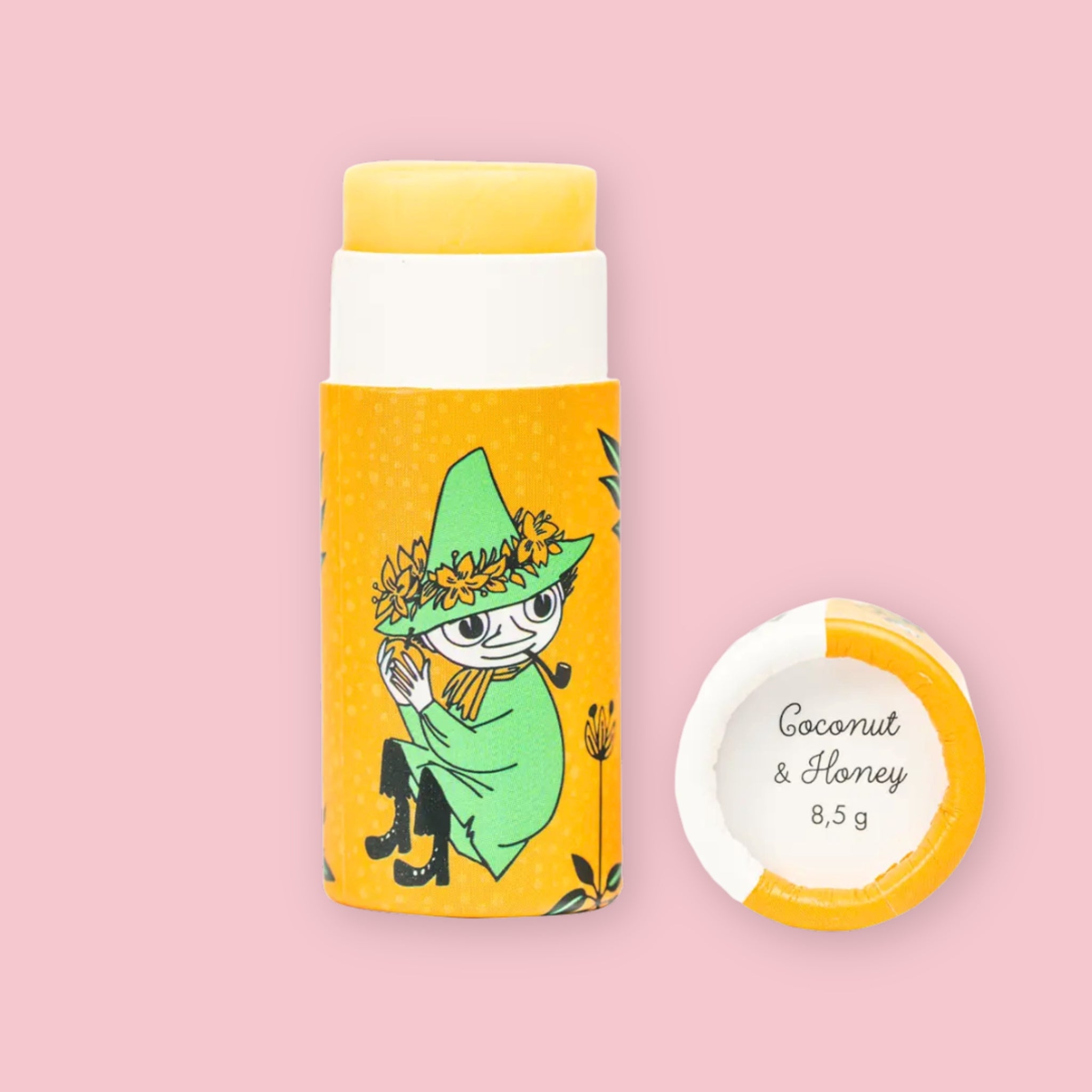 Open Coconut & Honey Moomin lip balm tube with yellow balm visible, illustrated with the Snufkin character on yellow packaging, next to the round lid printed with "Coconut & Honey 8,5 g"