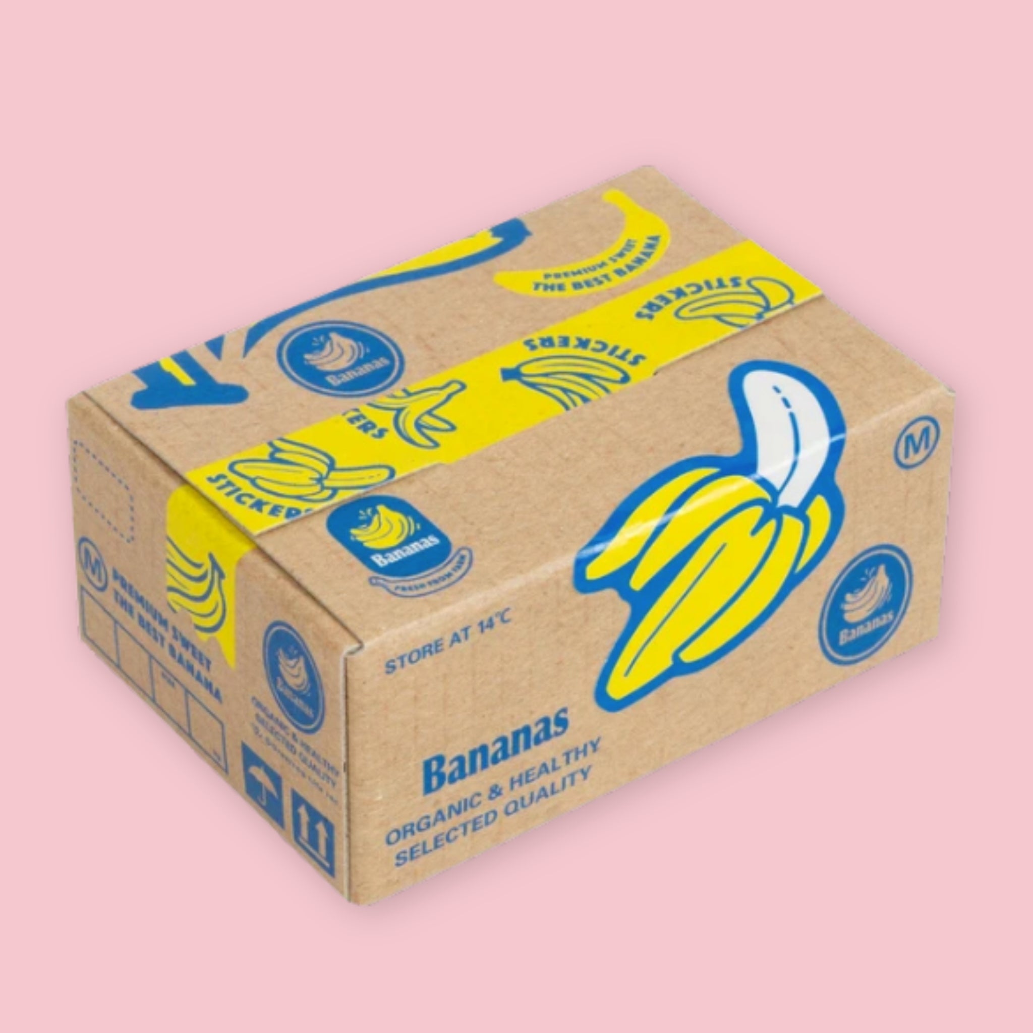 Box of Hako stickers designed to resemble a vintage banana crate, with kraft brown packaging, bold yellow and blue banana illustrations, and "Bananas — Organic & Healthy Selected Quality" branding, on a pink background.