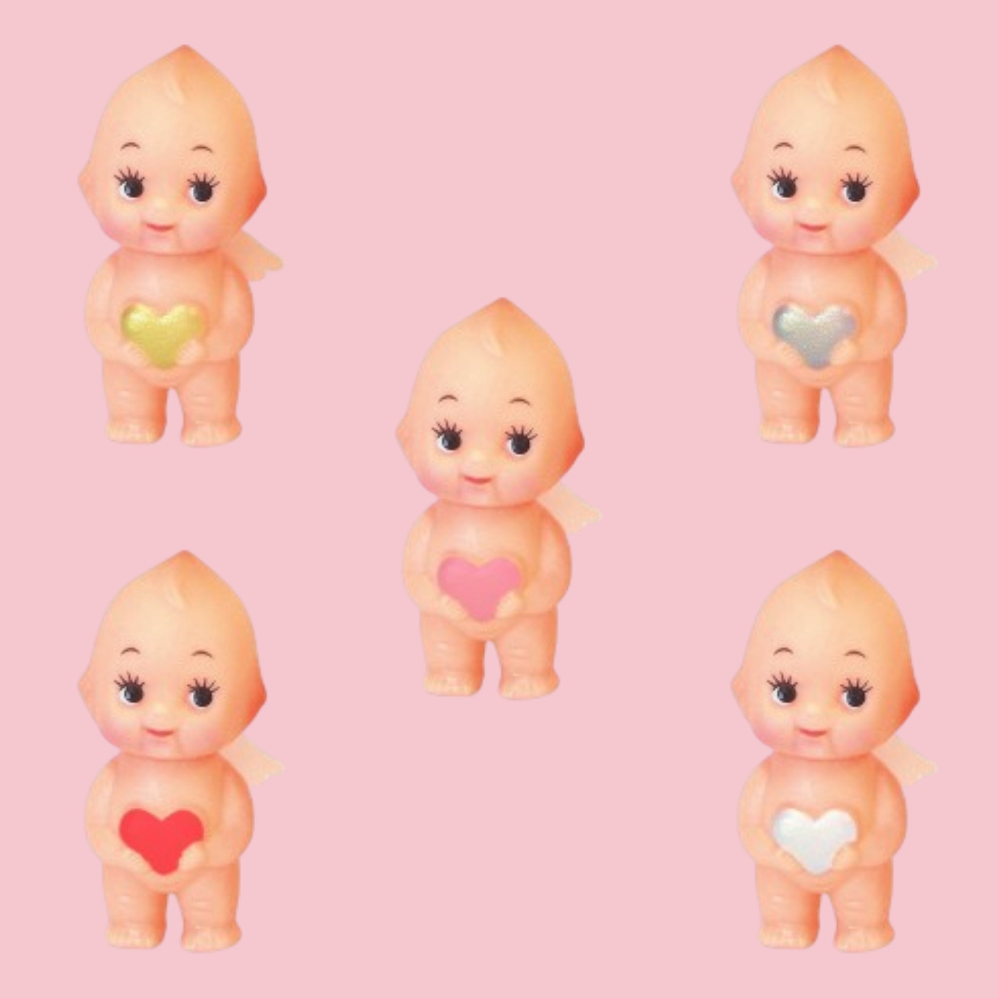Obitsu Kewpie angel dolls holding heart charms in red, pink, yellow, silver, and white on pink background.